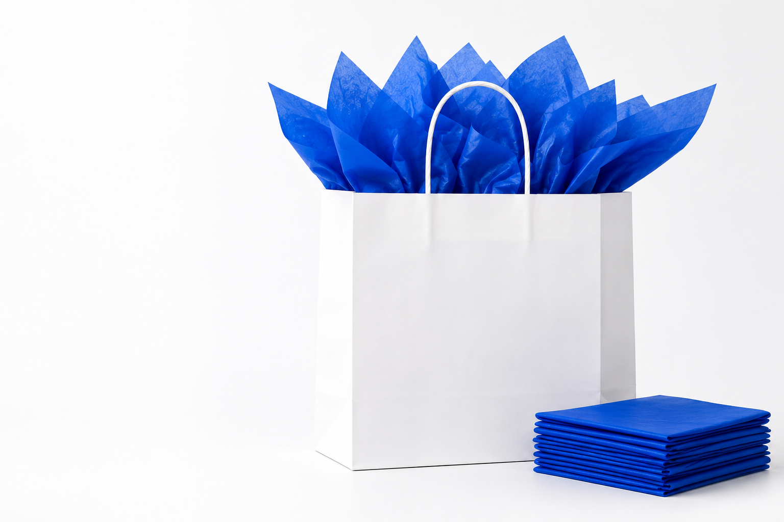 White retail bag with parade blue tissue paper and folded tissue stack